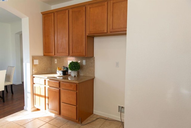 kitchen featuring light tile patterned floors and decorative backsplash