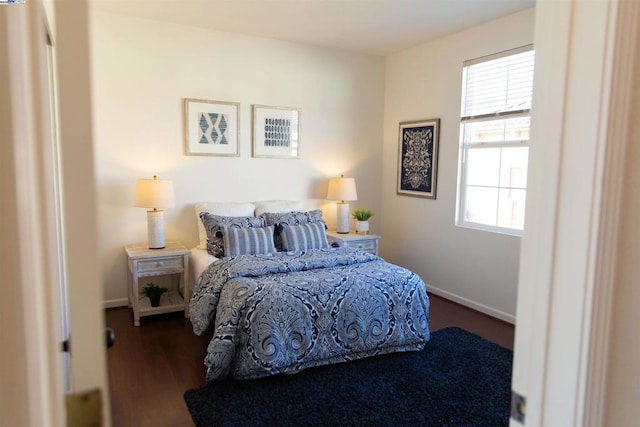 bedroom with dark hardwood / wood-style floors