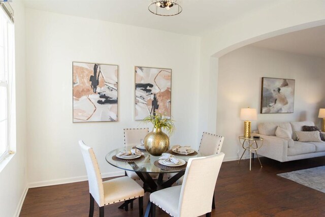 dining space with dark hardwood / wood-style flooring