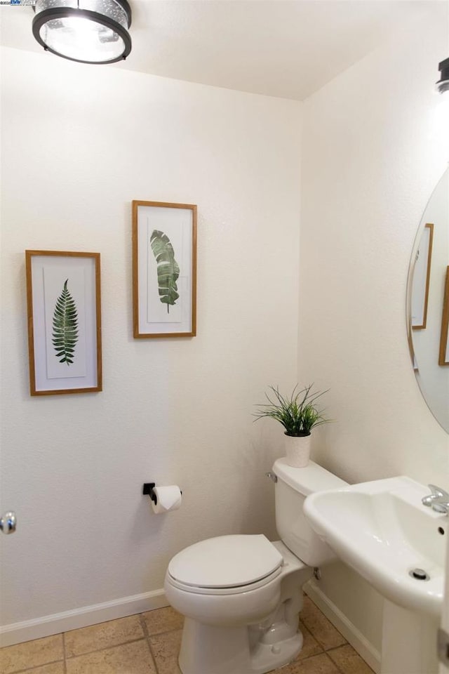 bathroom with sink, tile patterned floors, and toilet