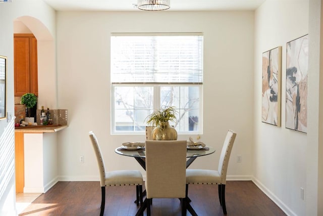 dining space with wood-type flooring