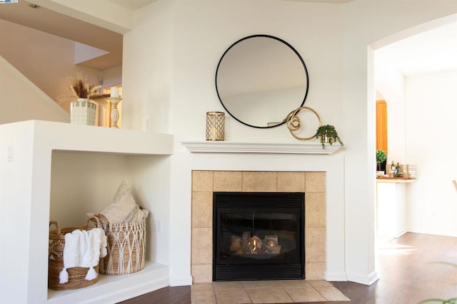 interior details featuring a tiled fireplace