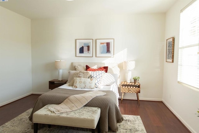 bedroom with dark wood-type flooring