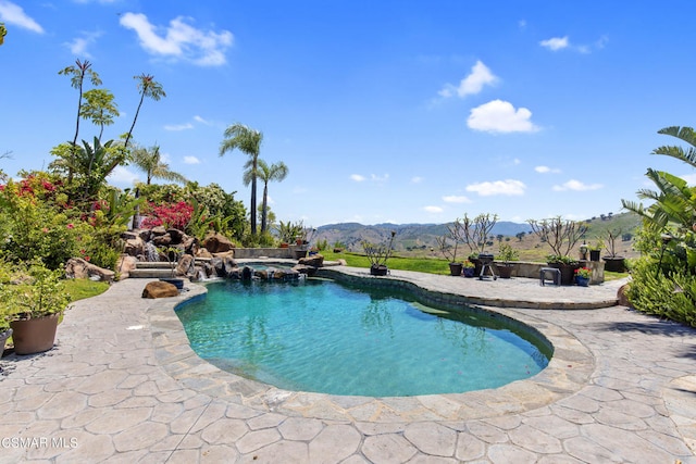 view of pool featuring a mountain view and a patio area