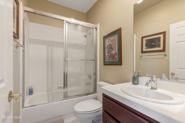 full bathroom with vanity, shower / bath combination with glass door, and toilet