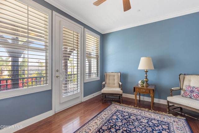 sitting room featuring a healthy amount of sunlight, ornamental molding, and hardwood / wood-style floors