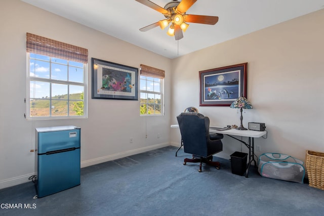 carpeted office space with ceiling fan