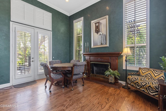 dining area with french doors, ornamental molding, hardwood / wood-style floors, and plenty of natural light