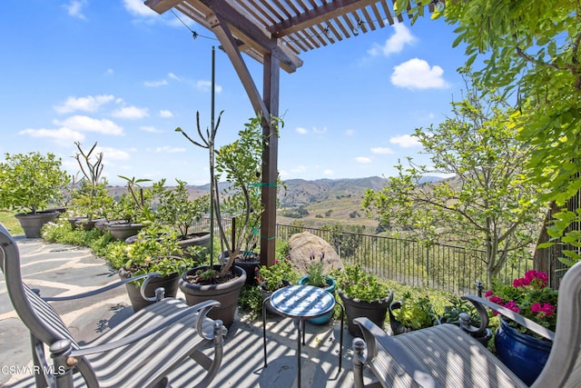 view of patio featuring a mountain view and a pergola