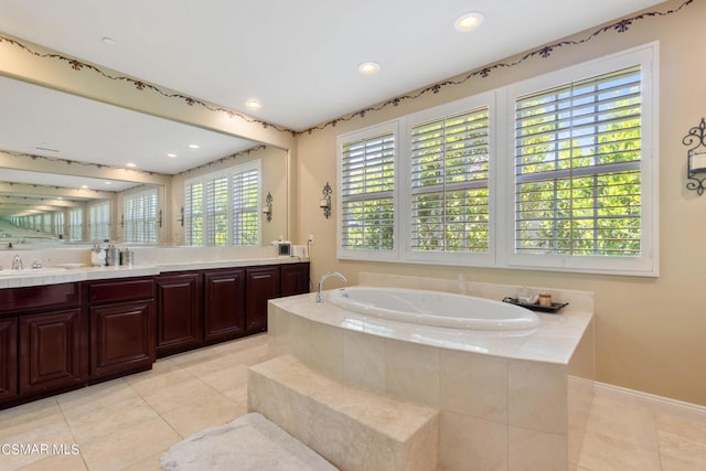 bathroom featuring vanity, tiled bath, and tile patterned floors