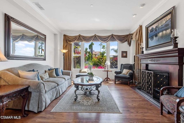 living room featuring ornamental molding, dark hardwood / wood-style floors, and a healthy amount of sunlight