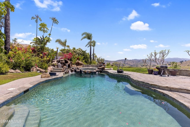 view of pool with a patio and a mountain view