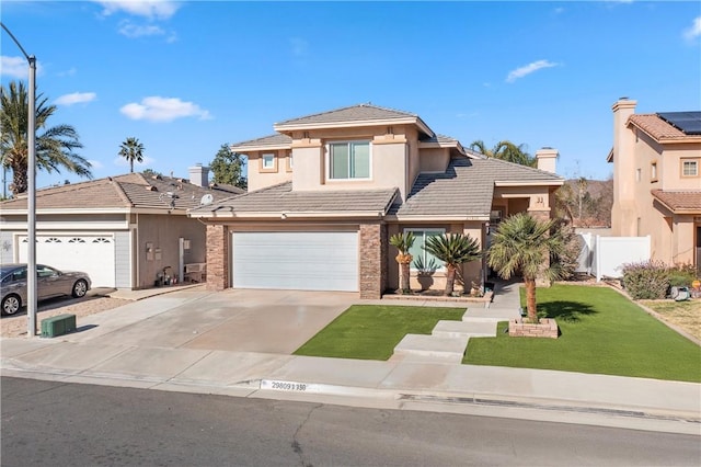 prairie-style home featuring concrete driveway, a tile roof, fence, a front yard, and stucco siding