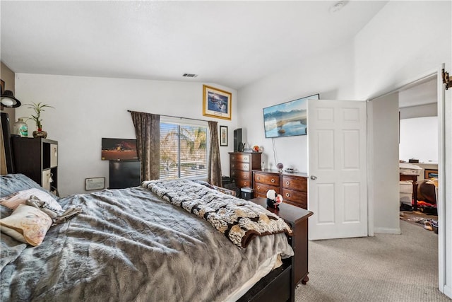 bedroom featuring light carpet and visible vents