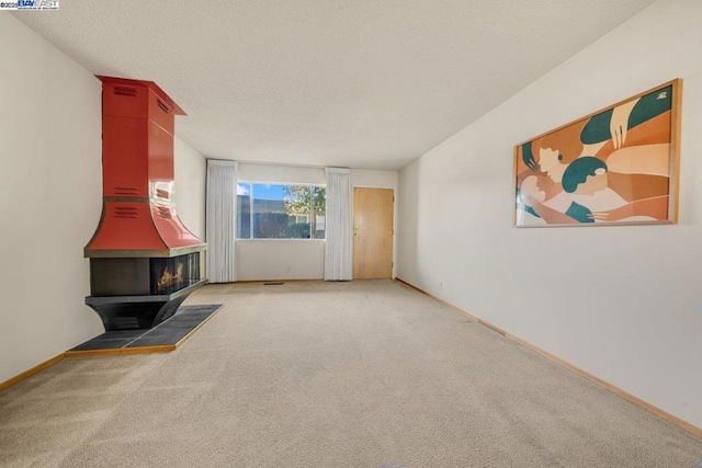 living room with carpet and a wood stove