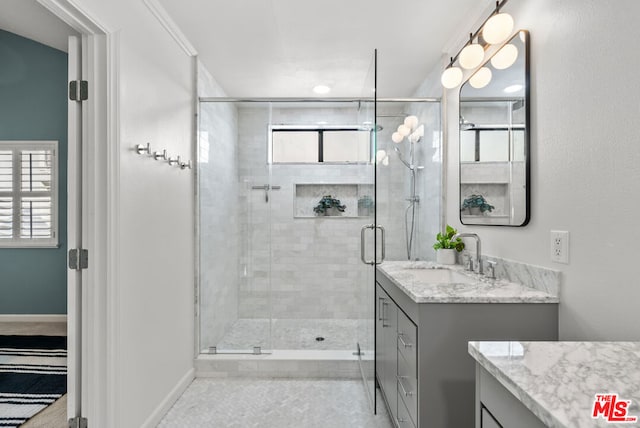 bathroom featuring vanity, tile patterned floors, and walk in shower