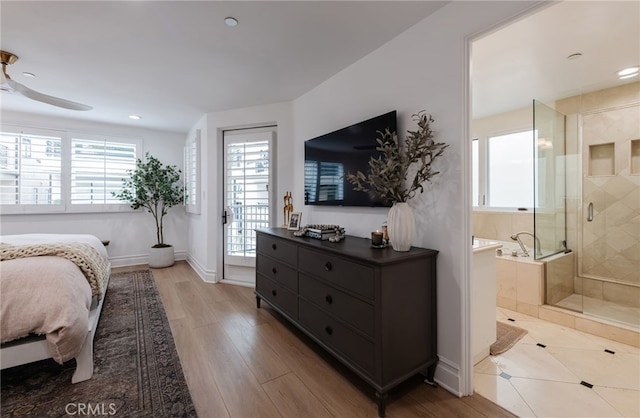 bedroom featuring baseboards, ensuite bath, light wood-style flooring, access to outside, and recessed lighting