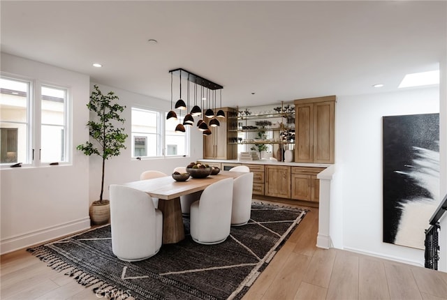 dining room with baseboards, light wood finished floors, a chandelier, and recessed lighting