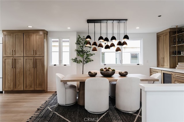 dining area featuring light wood-style floors, recessed lighting, and wine cooler