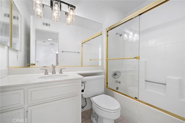 full bathroom with vanity, tile patterned flooring, shower / bath combination with glass door, and toilet