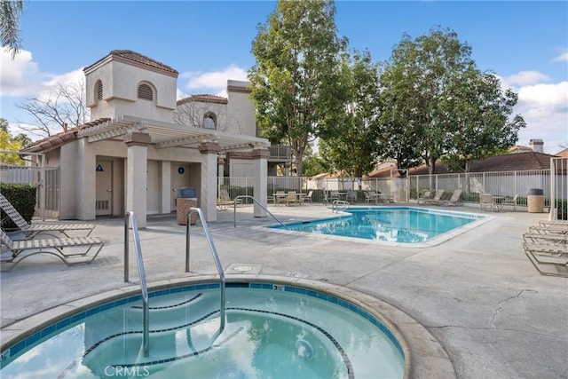 view of swimming pool with a hot tub, a patio, and a pergola