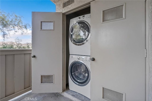 laundry area with stacked washer and dryer