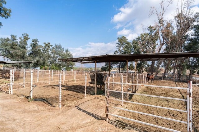 view of yard featuring an outdoor structure and a rural view