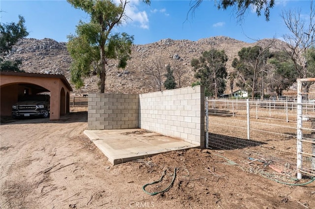 view of yard featuring a rural view and a mountain view