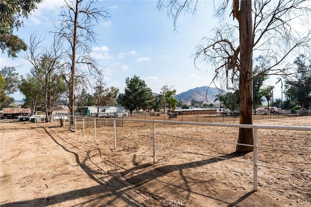 view of yard featuring a mountain view and a rural view