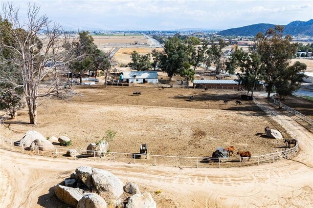 birds eye view of property featuring a mountain view and a rural view