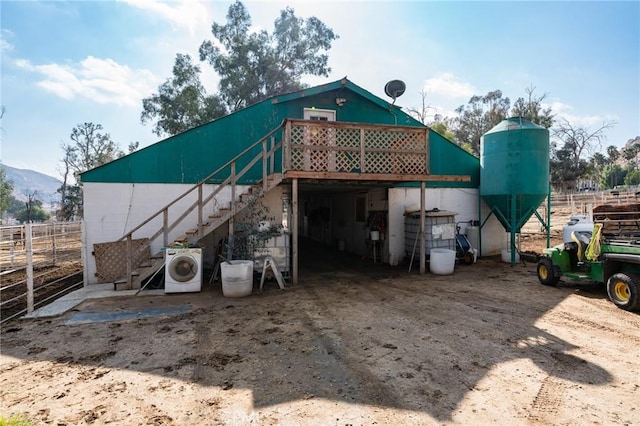 rear view of house with washer / clothes dryer and a mountain view