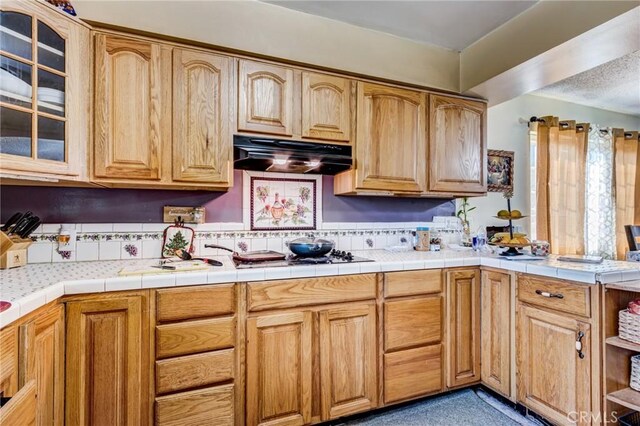 kitchen with gas stovetop and tile counters