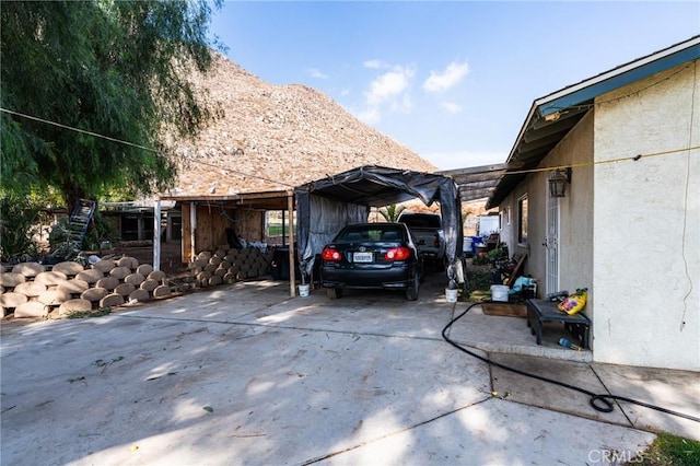 view of property exterior featuring a mountain view and a carport