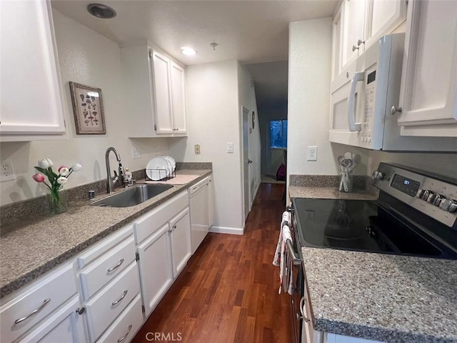 kitchen featuring stone counters, dark hardwood / wood-style floors, white cabinetry, sink, and white appliances