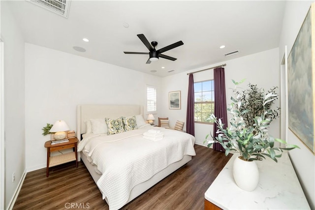 bedroom with dark hardwood / wood-style floors and ceiling fan