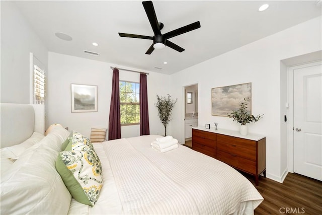 bedroom featuring ceiling fan, dark hardwood / wood-style flooring, and ensuite bath