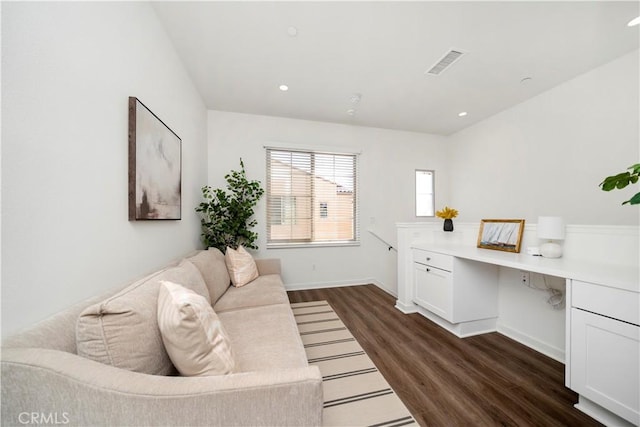 office with built in desk and dark hardwood / wood-style flooring