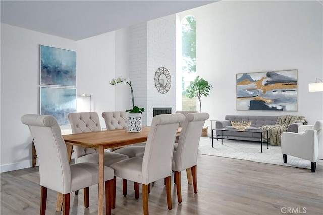 dining area with a fireplace and wood finished floors