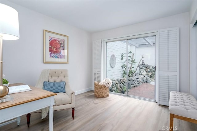 living area featuring wood finished floors and baseboards