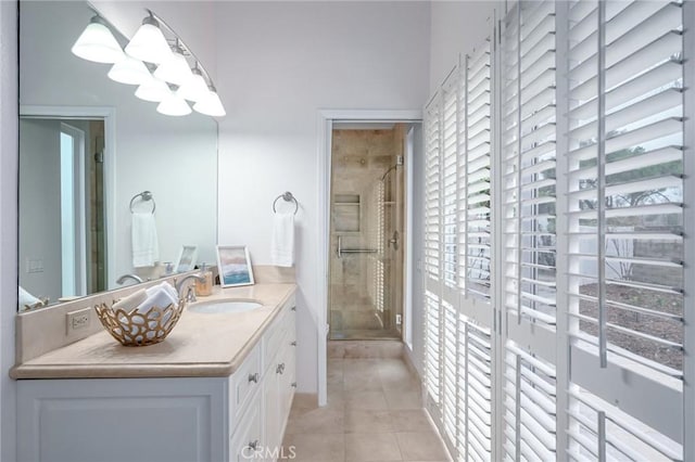 bathroom with tile patterned floors, vanity, and a shower stall