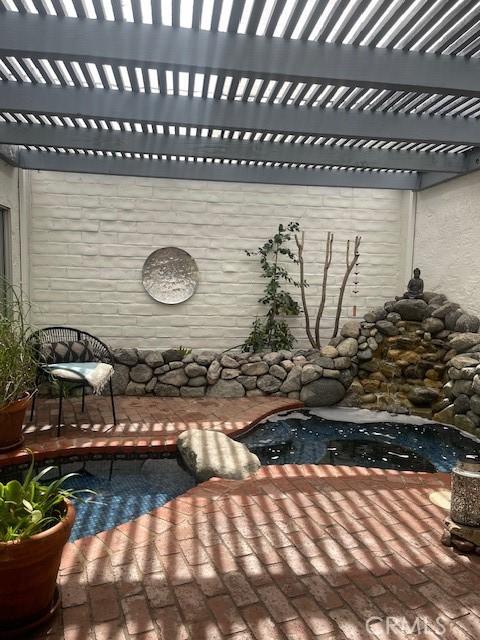 view of patio with an outdoor pool and a pergola