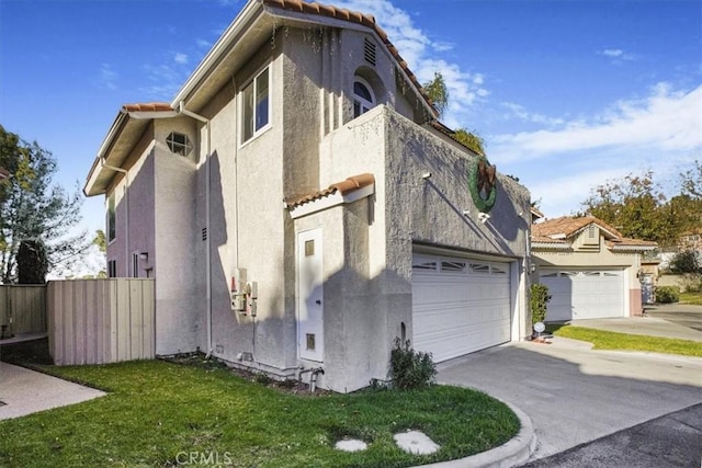 view of home's exterior featuring a garage and a yard