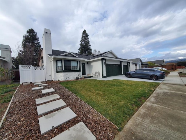 single story home with a garage and a front yard