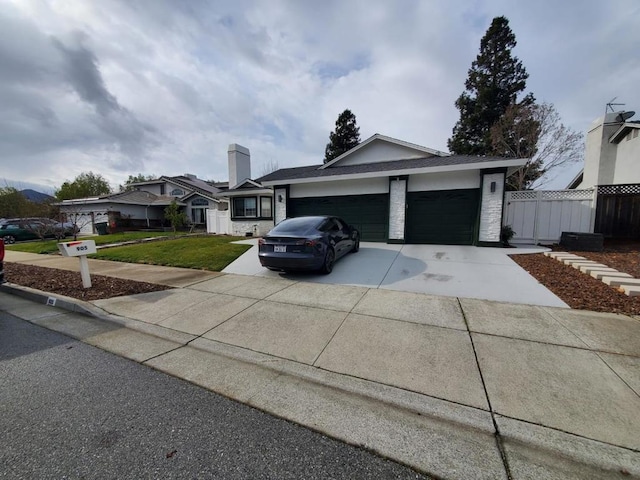 view of front of home featuring a garage and a front yard