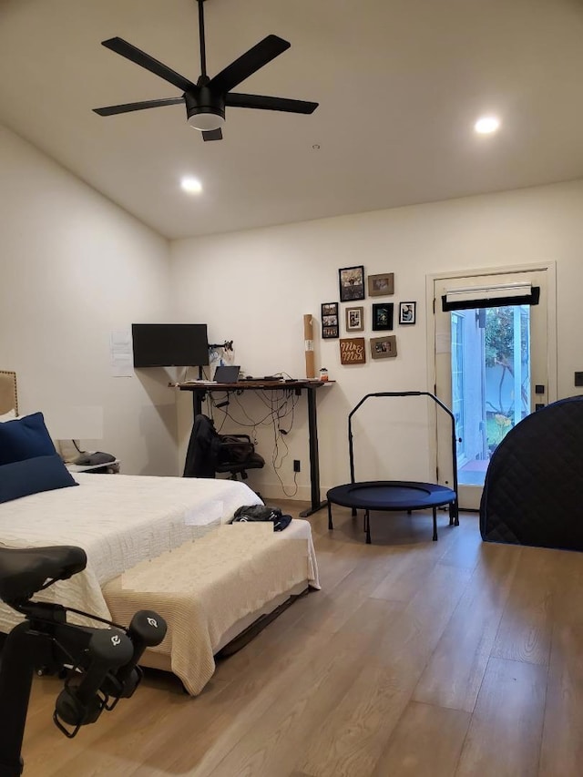 bedroom featuring hardwood / wood-style flooring, ceiling fan, and access to outside