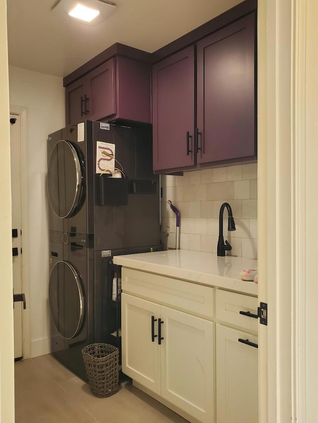 washroom featuring stacked washing maching and dryer