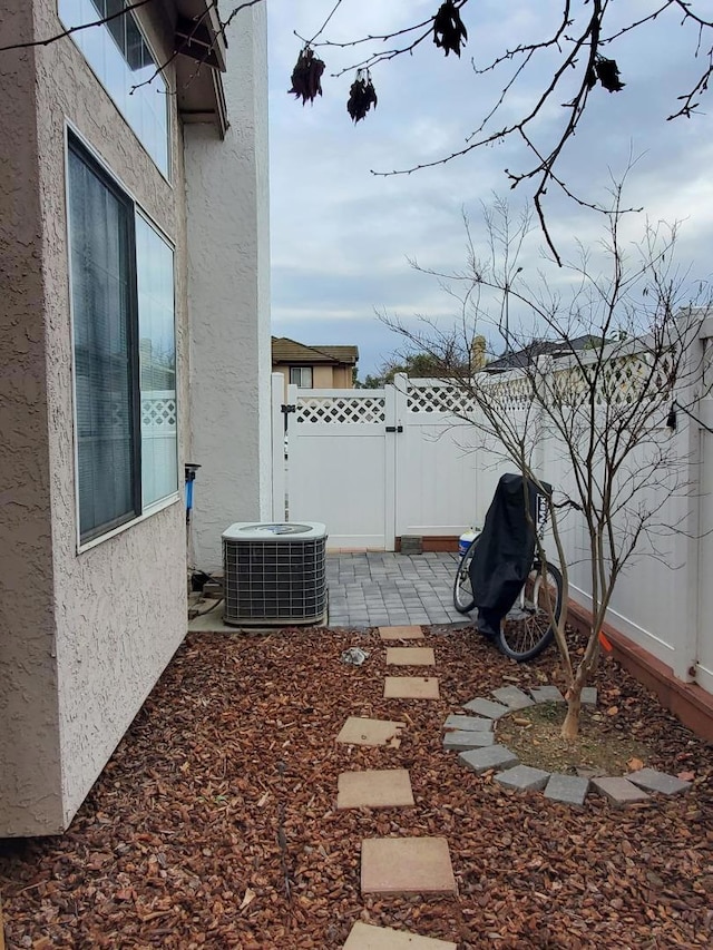 view of yard with a patio and central air condition unit