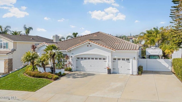 mediterranean / spanish-style home with a garage