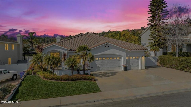 mediterranean / spanish house with a garage