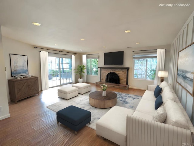 living room with light hardwood / wood-style flooring and a fireplace